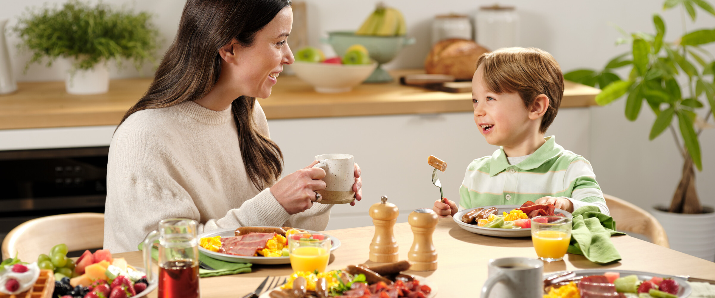 Closeup of mother and child eating breakfast