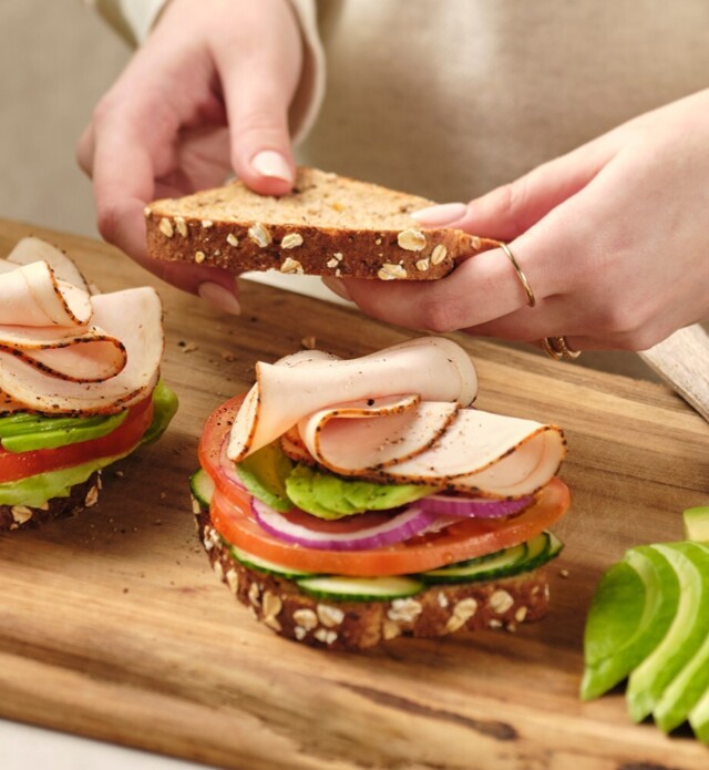 Closeup of a woman making a sandwich