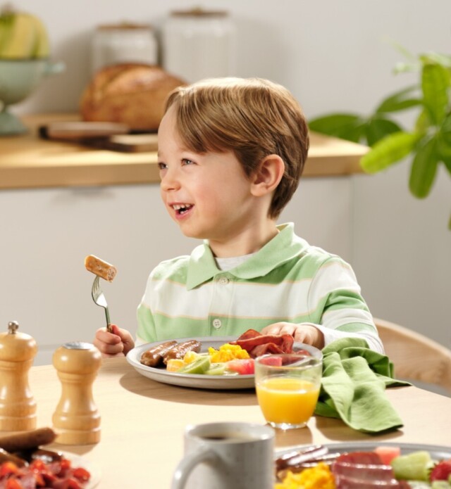 Closeup of mother and child eating breakfast