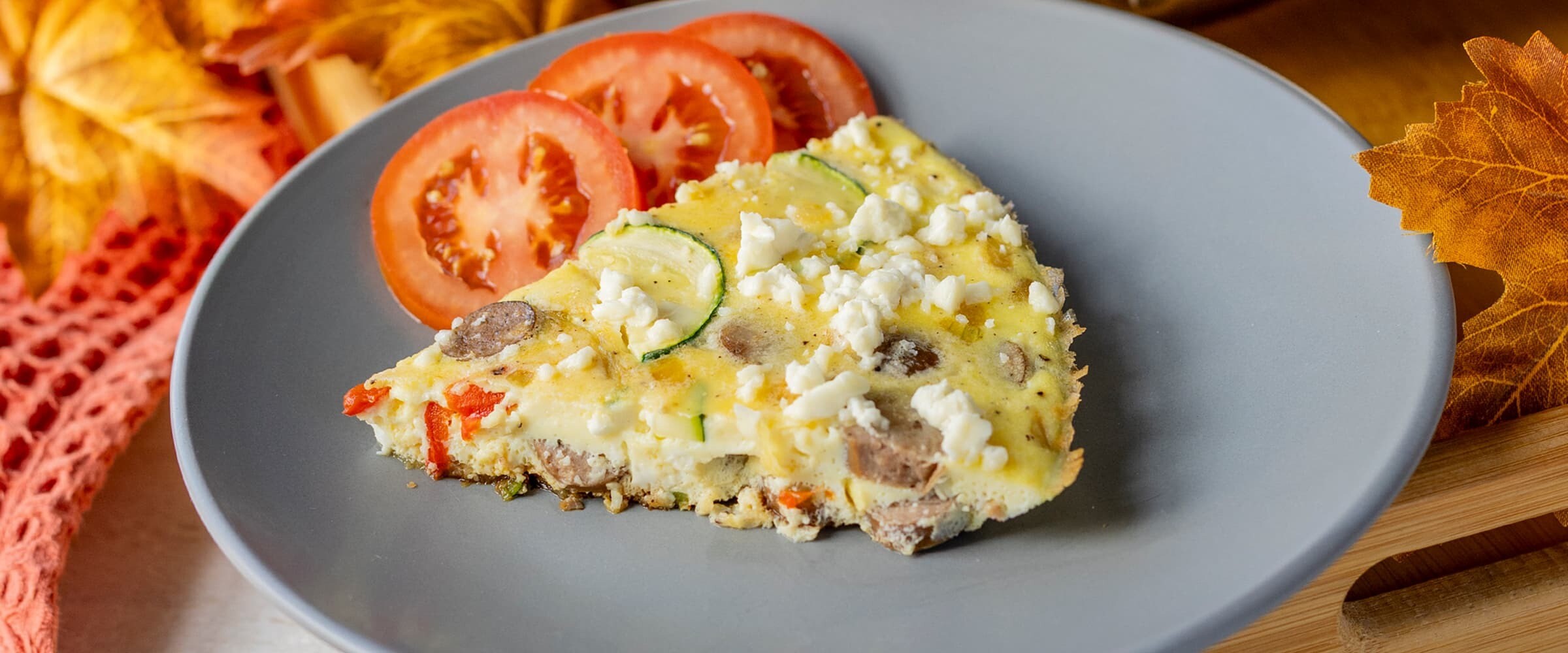 Close up of a slice of frittata served on a plate.