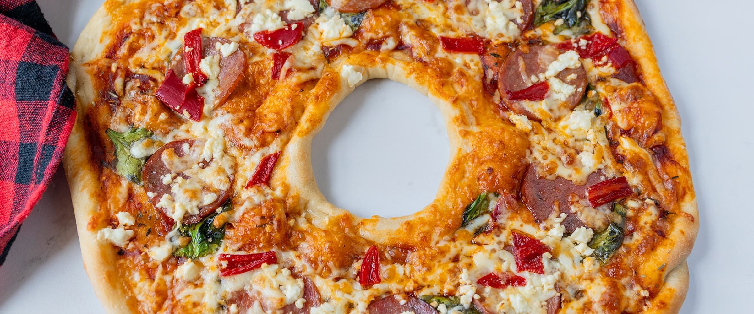 Pizza Wreath displayed on a white plate.