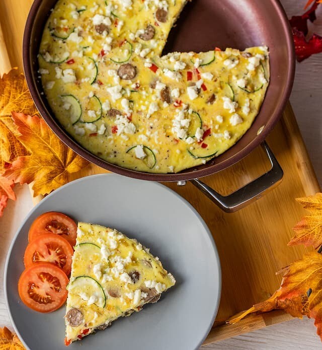 Close up of a slice of frittata served on a plate.