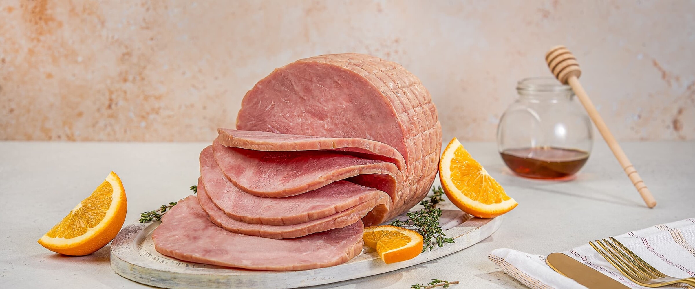 Close up of sliced ham served on a tray.