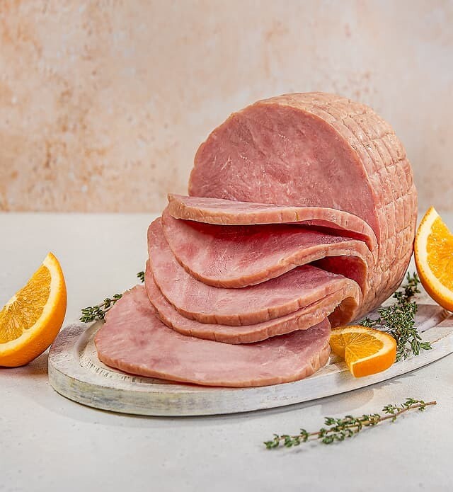 Close up of sliced ham served on a tray.